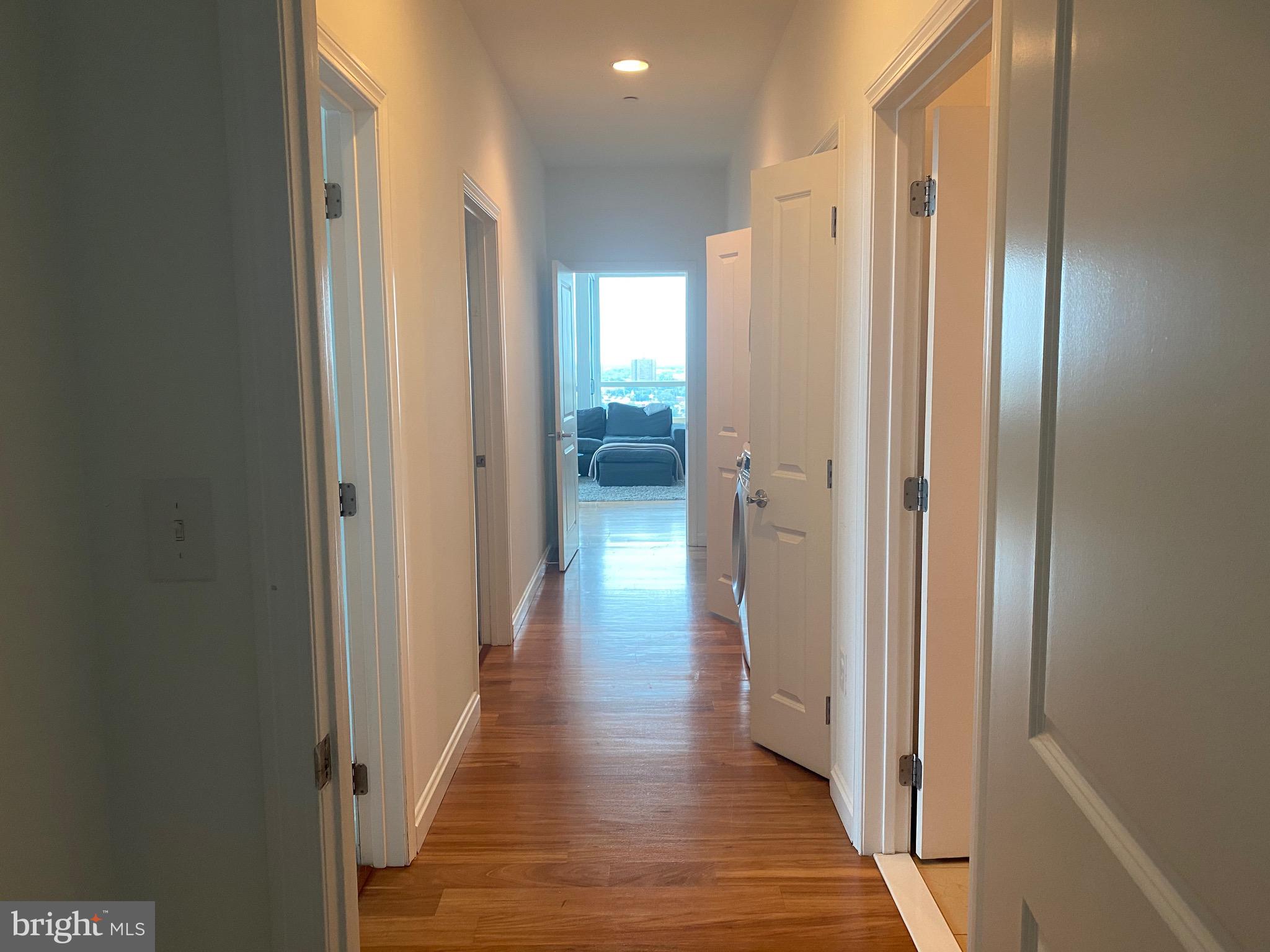 901 North Penn Street, Unit R2101 Philadelphia, PA 19123 - Photo 24 of 33 a view of a hallway with wooden floor and a bathroom