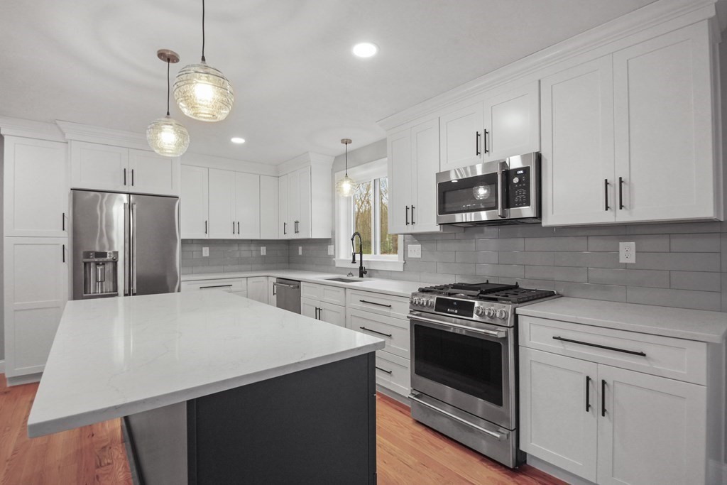 529 Chadwick Road Haverhill, MA 01835 - Photo 11 of 38 a kitchen with a white cabinets and white appliances