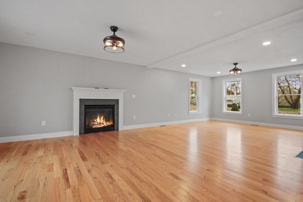 529 Chadwick Road Haverhill, MA 01835 - Photo 18 of 38 a view of empty room with wooden floor and a fireplace