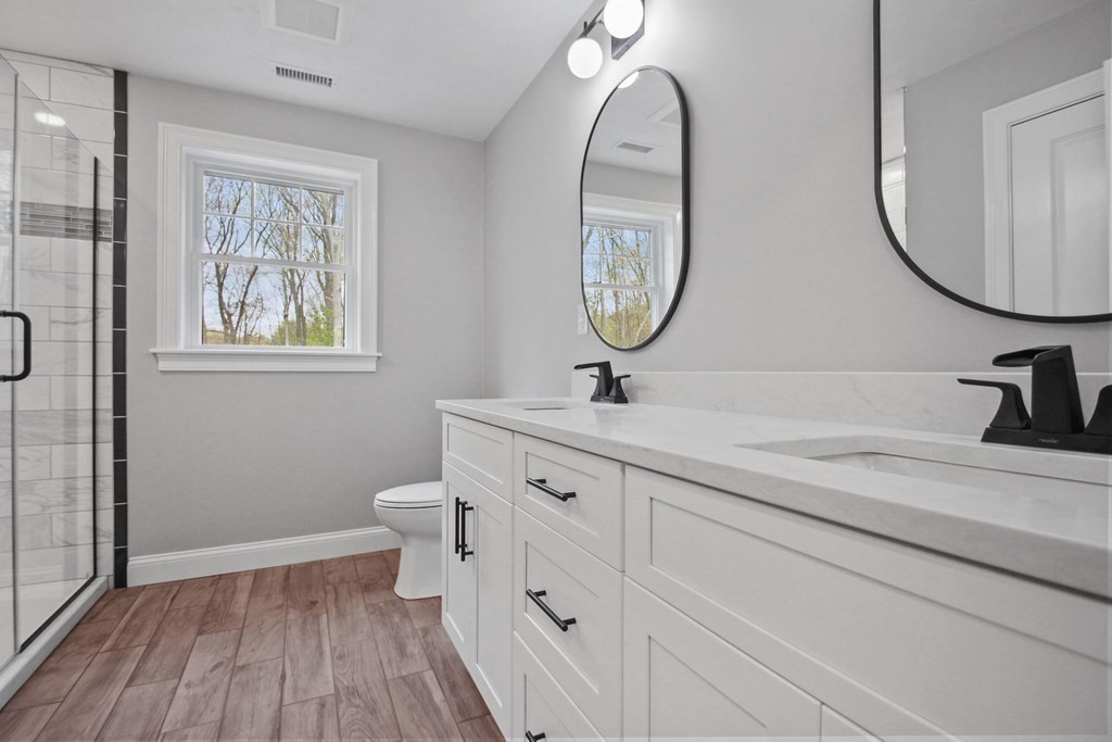 529 Chadwick Road Haverhill, MA 01835 - Photo 26 of 38 a bathroom with a double vanity sink mirror and a toilet