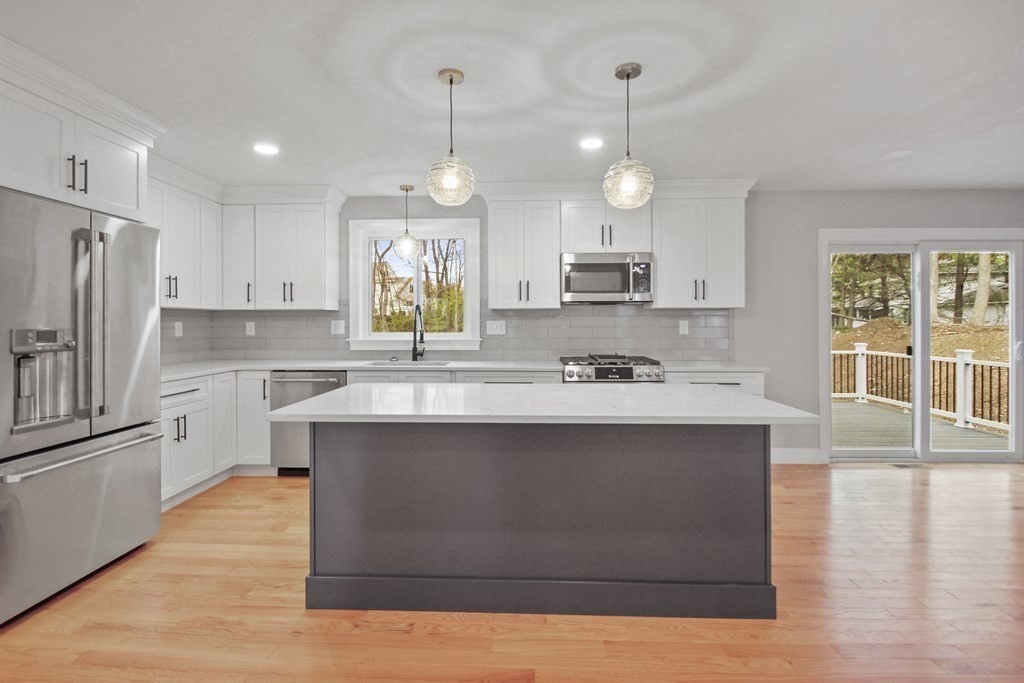 529 Chadwick Road Haverhill, MA 01835 - Photo 7 of 38 a kitchen with stainless steel appliances granite countertop a sink a stove and a refrigerator