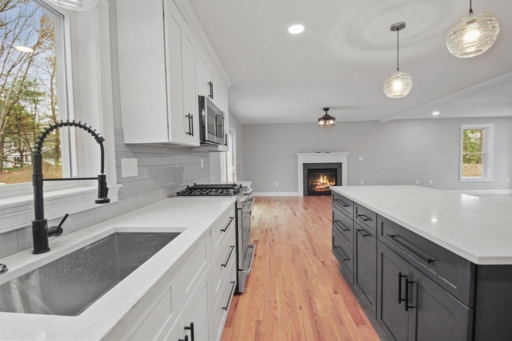 529 Chadwick Road Haverhill, MA 01835 - Photo 9 of 38 a kitchen with a sink stove and cabinets