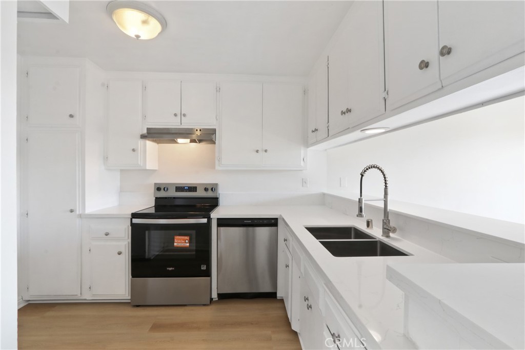 1187 East 3rd Street, Unit 215 Long Beach, CA 90802 - Photo 2 of 15 a kitchen with stainless steel appliances granite countertop a sink a stove and cabinets