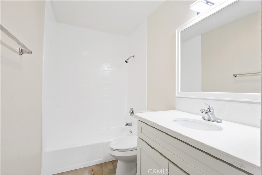 1187 East 3rd Street, Unit 215 Long Beach, CA 90802 - Photo 7 of 15 a bathroom with a sink toilet and a mirror