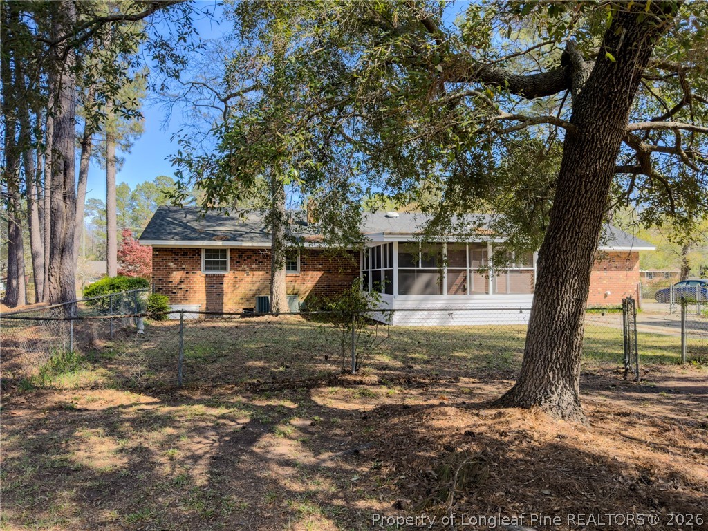 598 Forest Road Lumberton, NC 28358 - Photo 23 of 25 a view of a house with yard tree and wooden fence