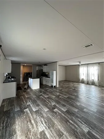 a view of a kitchen with a sink and cabinets