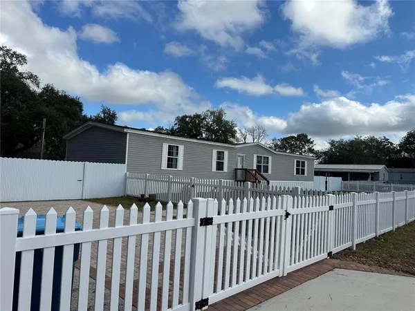 a view of a house with wooden fence