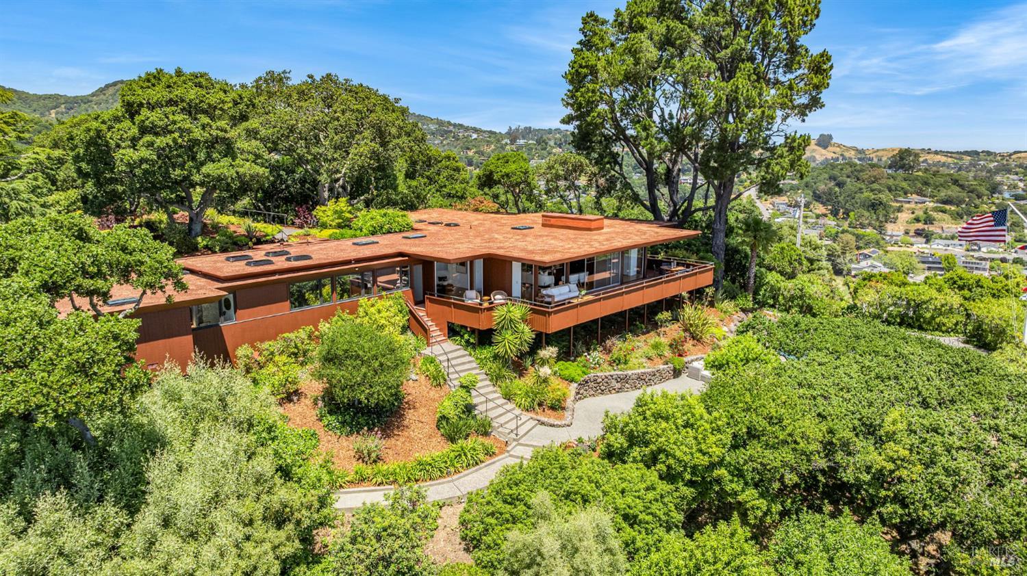 an aerial view of a house with a yard basket ball court and outdoor seating