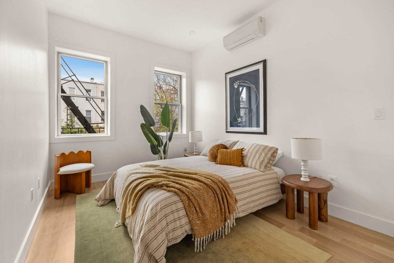 1230 Putnam Avenue, Unit 3 Brooklyn, NY 11221 - Photo 6 of 11 a bedroom with bed and a painting on the wall