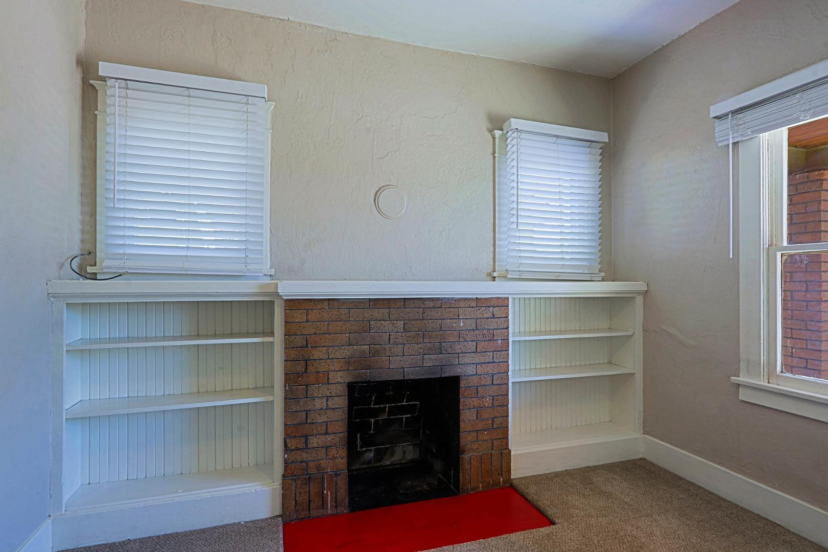841 North 9th Avenue Phoenix, AZ 85007 - Photo 6 of 21 a living room with a fireplace cabinet and a window