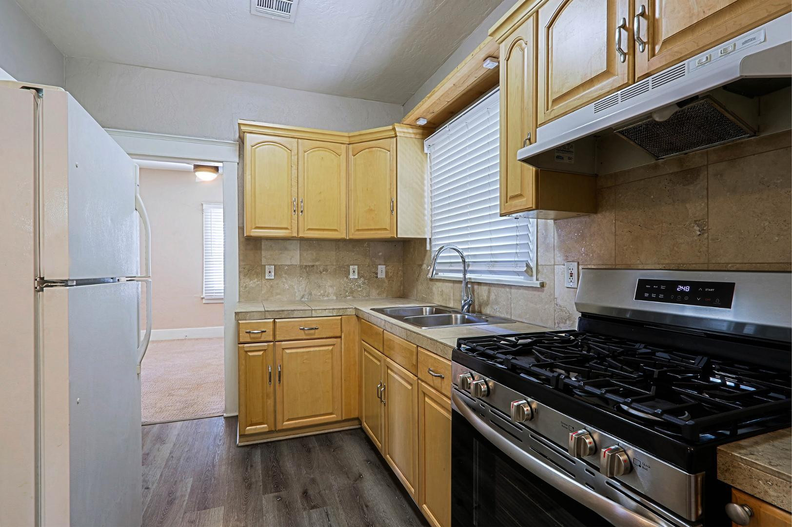 841 North 9th Avenue Phoenix, AZ 85007 - Photo 8 of 21 a kitchen with stainless steel appliances granite countertop a stove and a refrigerator