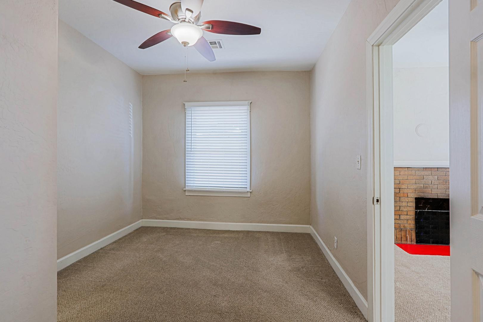 841 North 9th Avenue Phoenix, AZ 85007 - Photo 10 of 21 an empty room with chandelier fan and windows