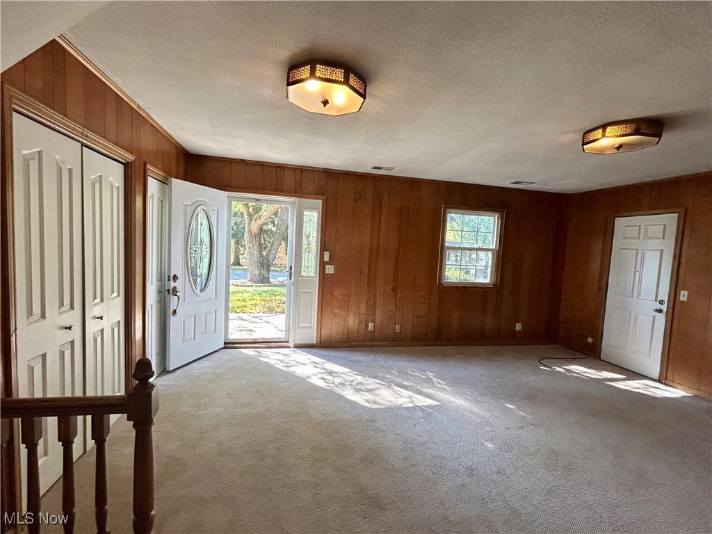 399 Abbyshire Road Green, OH 44319 - Photo 8 of 48 Carpeted family with wood walls and a textured ceiling