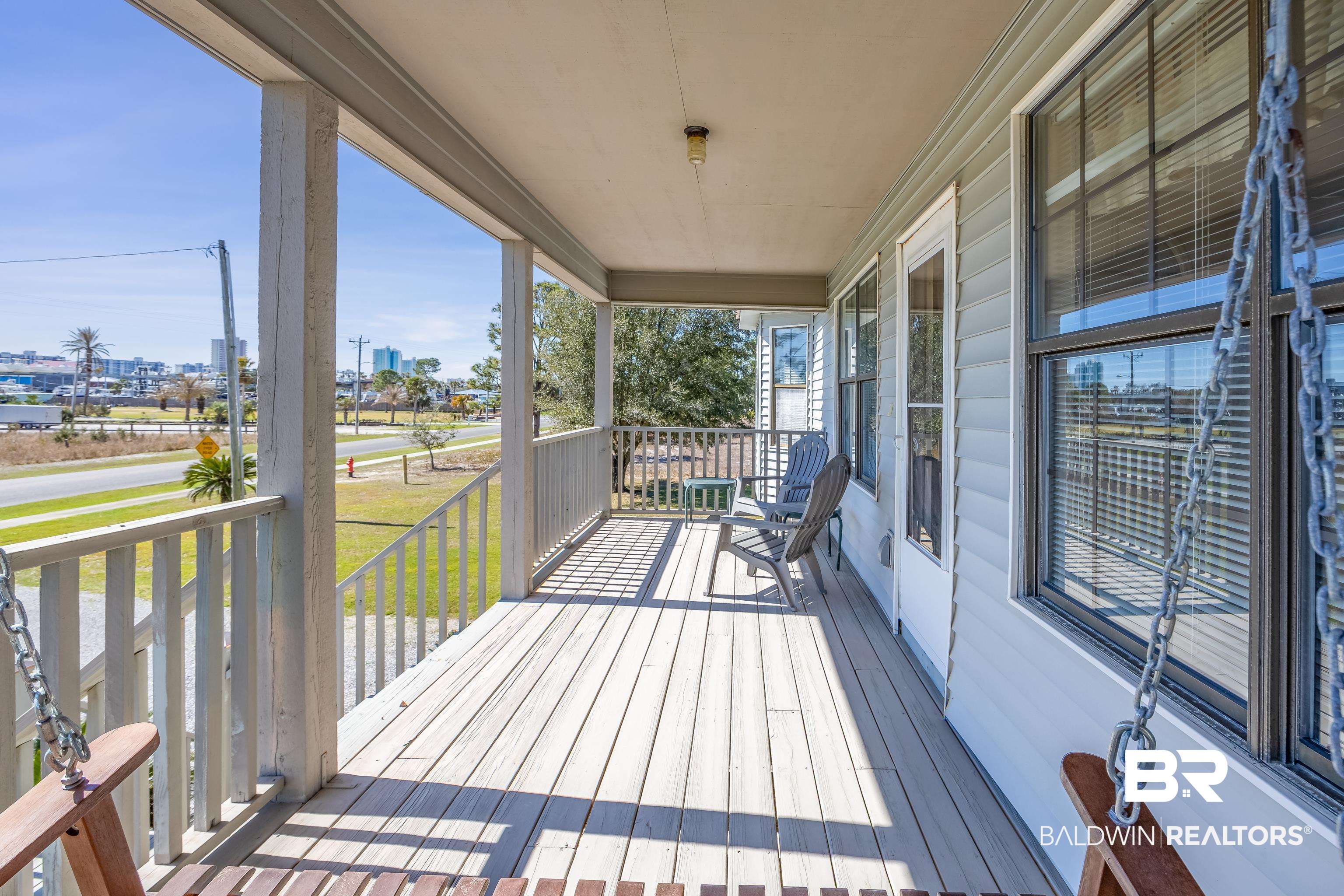 27321 Marina Road Orange Beach, AL 36561 - Photo 8 of 55 Wooden terrace featuring covered porch