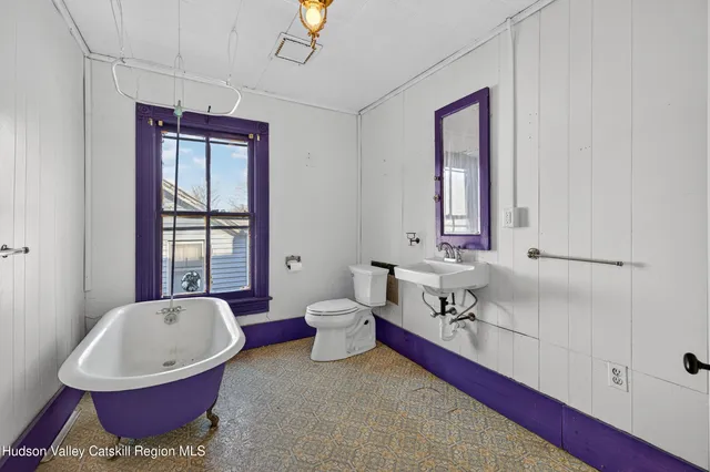 a bathroom with a bathtub and a sink