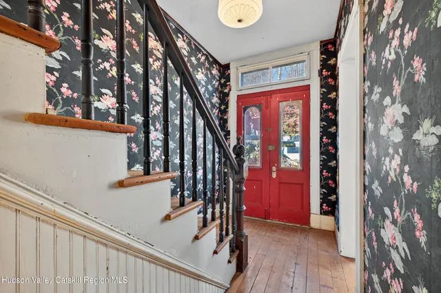 a view of entryway with stairs and wooden floor