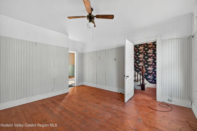wooden floor in an empty room with a window