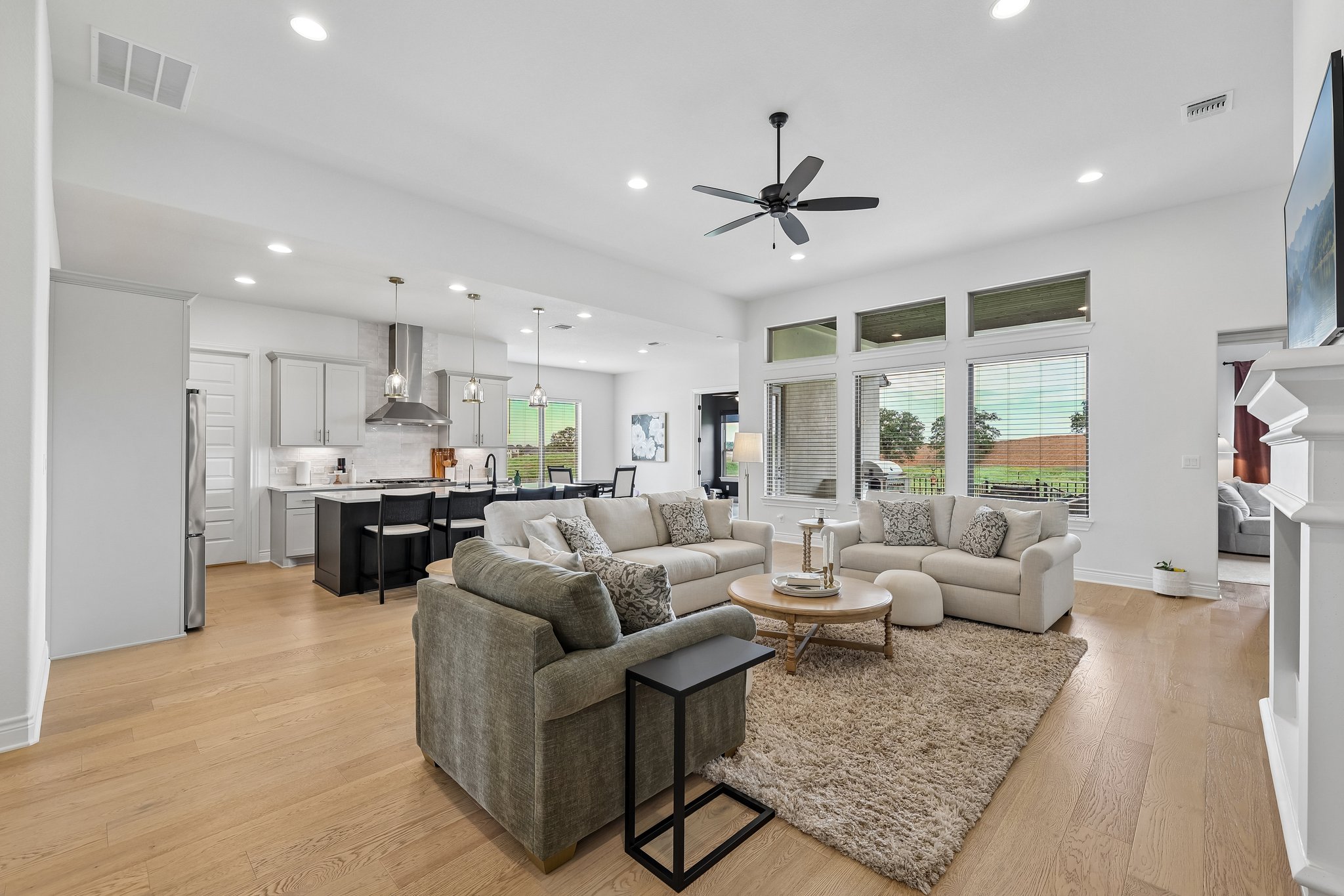 130 Firethorn Loop Bastrop, TX 78602 - Photo 7 of 38 Open-concept living area featuring light wood-finish flooring, recessed lighting, and a contemporary ceiling fan