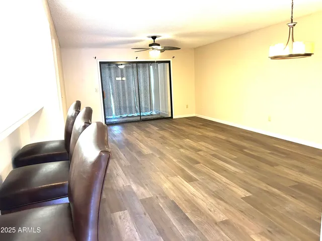 a view of a ceiling fan and wooden floor
