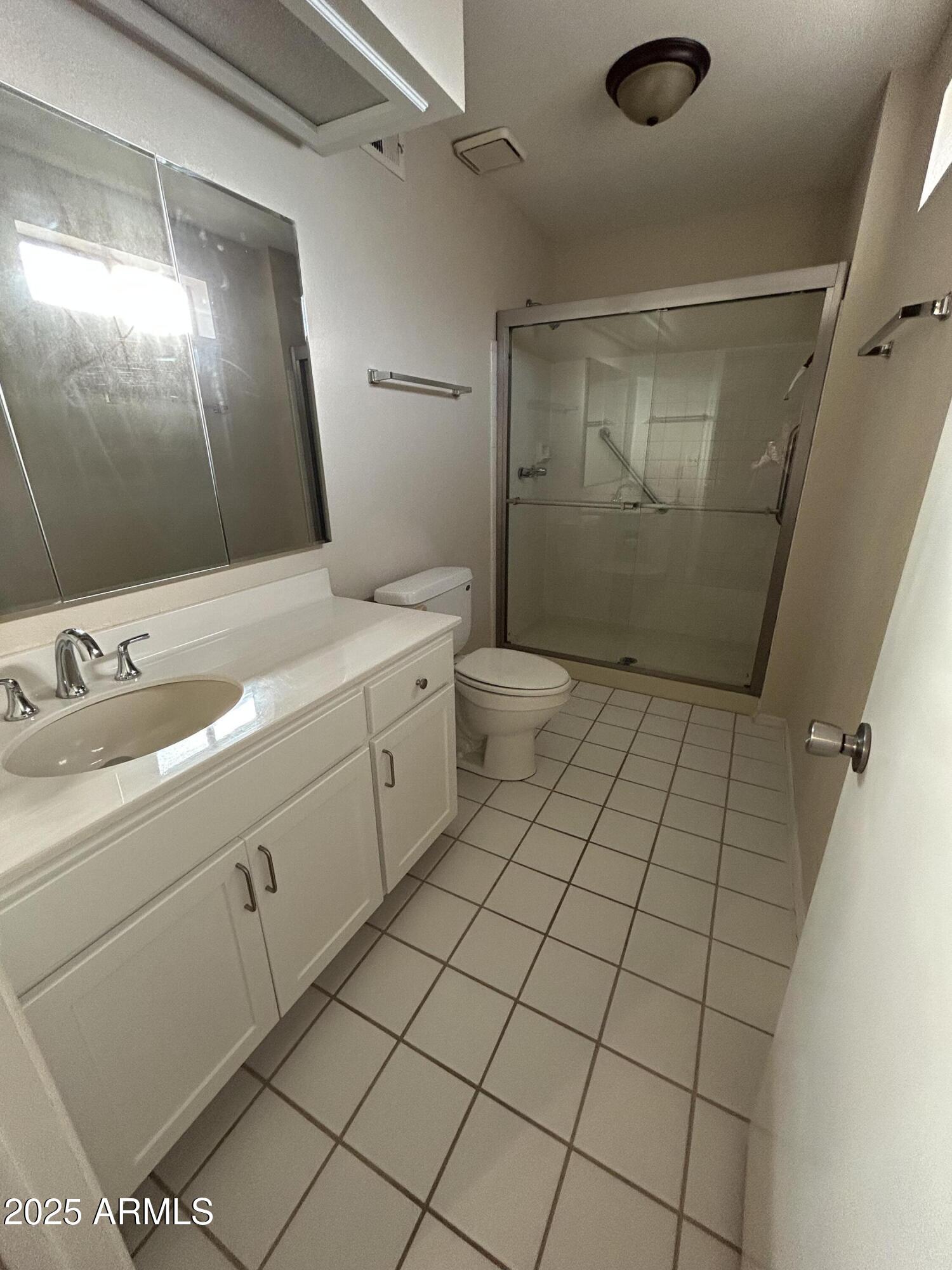 1021 South Greenfield Road, Unit 1198 Mesa, AZ 85206 - Photo 19 of 29 a bathroom with a sink a toilet and a mirror