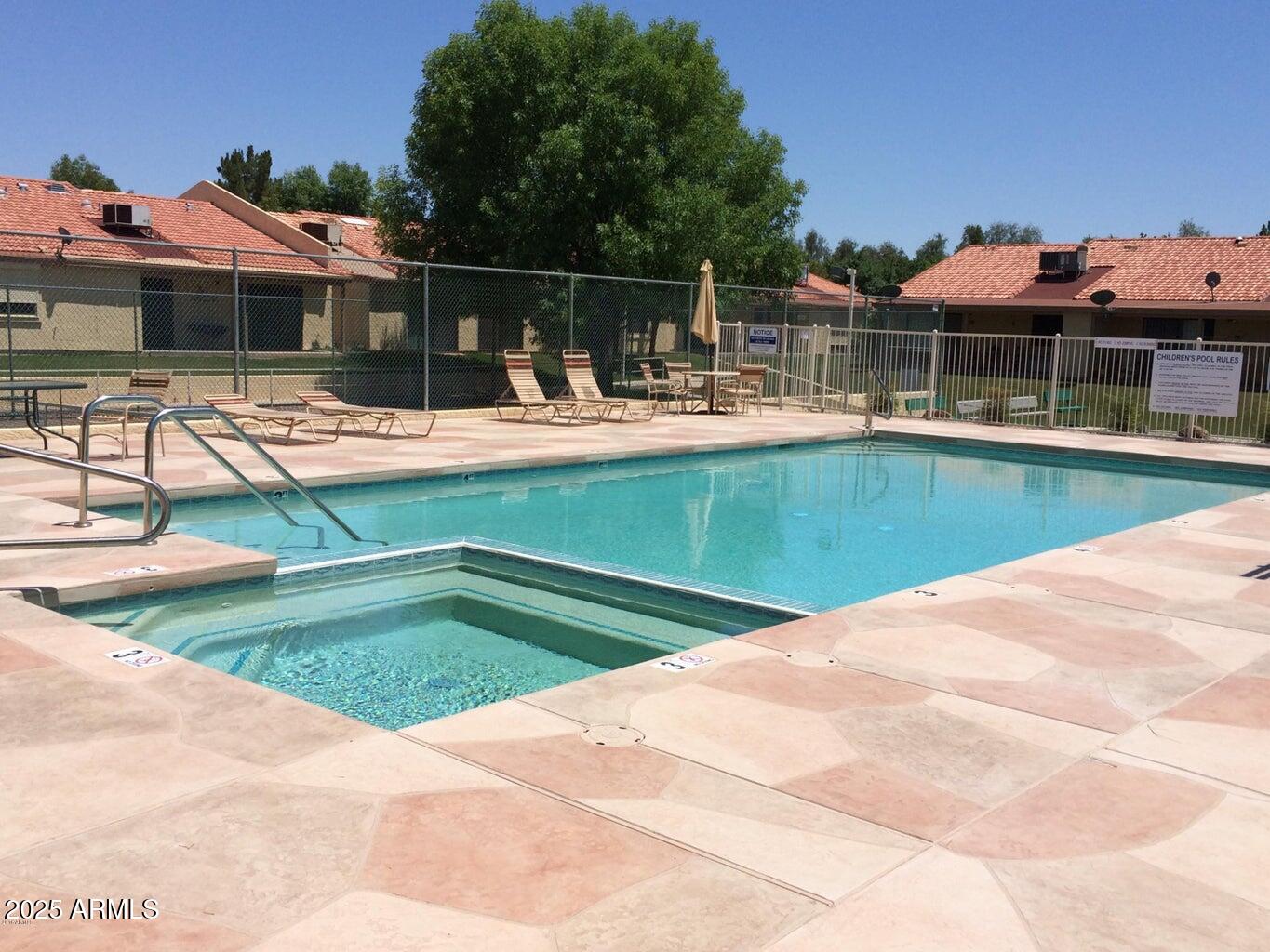 1021 South Greenfield Road, Unit 1198 Mesa, AZ 85206 - Photo 23 of 29 a view of a swimming pool with a lounge chairs