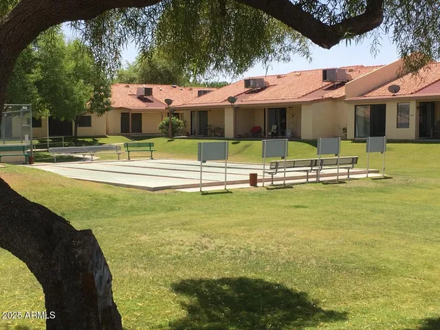 a view of a patio with table and chairs a barbeque