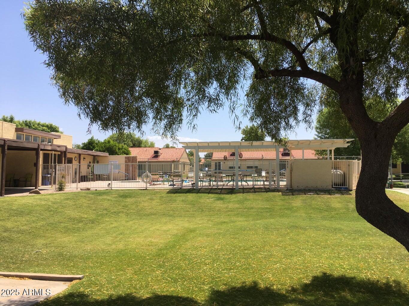 1021 South Greenfield Road, Unit 1198 Mesa, AZ 85206 - Photo 27 of 29 a view of a swimming pool with an outdoor seating