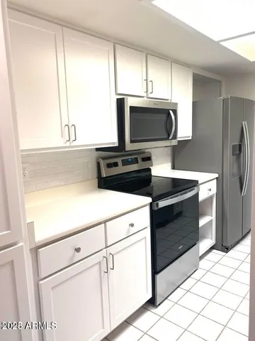 a kitchen with stainless steel appliances a sink and cabinets