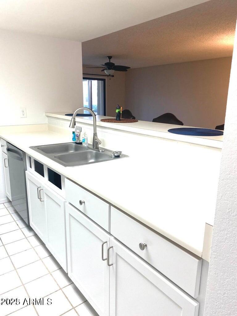 1021 South Greenfield Road, Unit 1198 Mesa, AZ 85206 - Photo 9 of 29 a kitchen with a sink and white cabinets