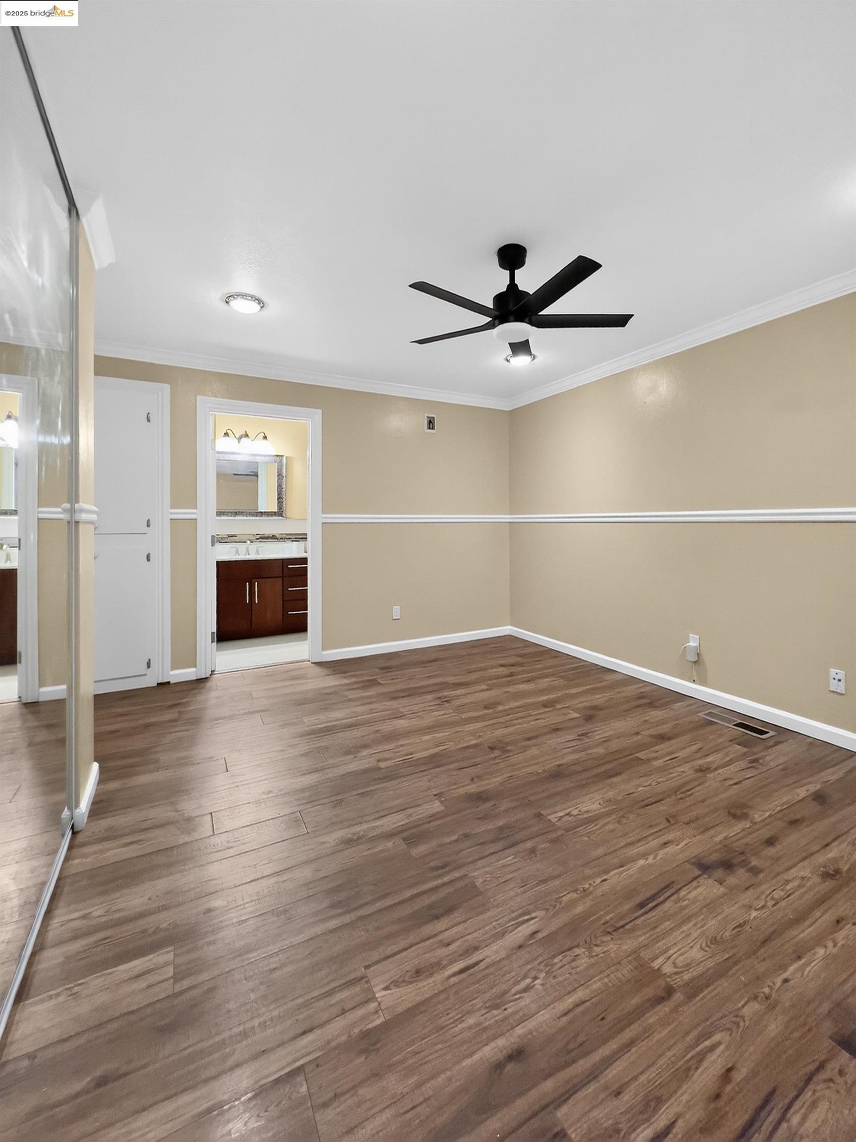 2322 Peachtree Circle Antioch, CA 94509 - Photo 6 of 43 an empty room with wooden floor and a ceiling fan