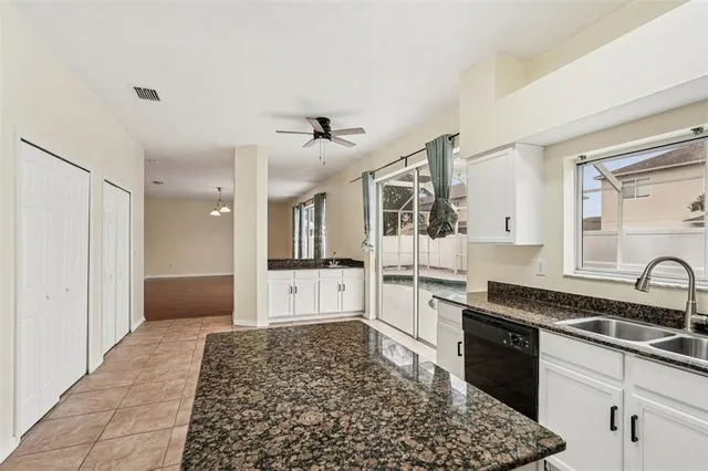 a large white kitchen with a stove a sink and a refrigerator