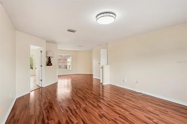 a view of a room with wooden floor