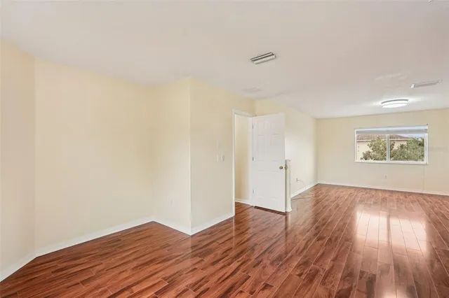 a view of an empty room and wooden floor