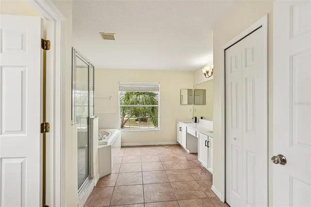 a bathroom with a glass door shower and a sink