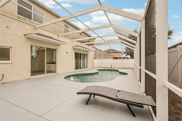 a backyard of a house with table and chairs