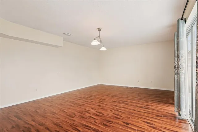 a view of a room with wooden floor and white walls