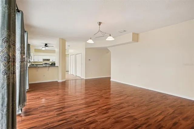 a view of a kitchen with wooden floor and a kitchen
