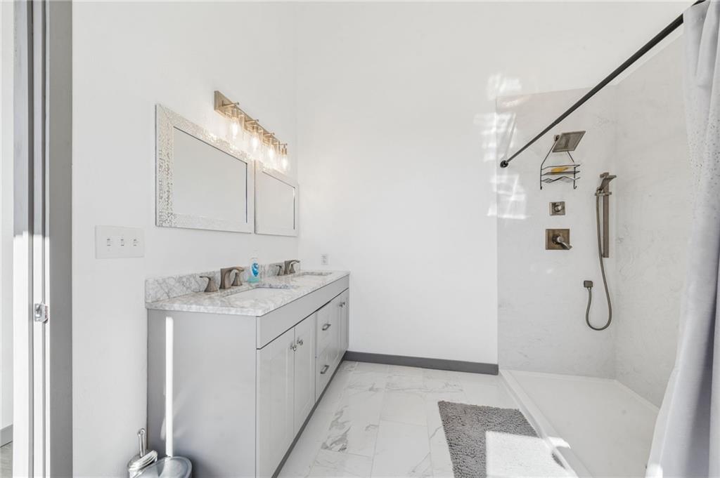 1029 Hoffman Road Smithton, PA 15479 - Photo 22 of 48 a bathroom with a granite countertop sink a toilet and shower