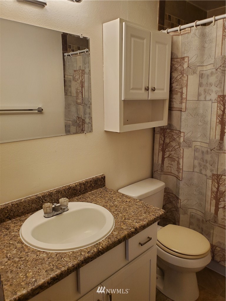 2728 Pine Road Northeast Bremerton, WA 98310 - Photo 11 of 21 a bathroom with a granite countertop sink and a mirror