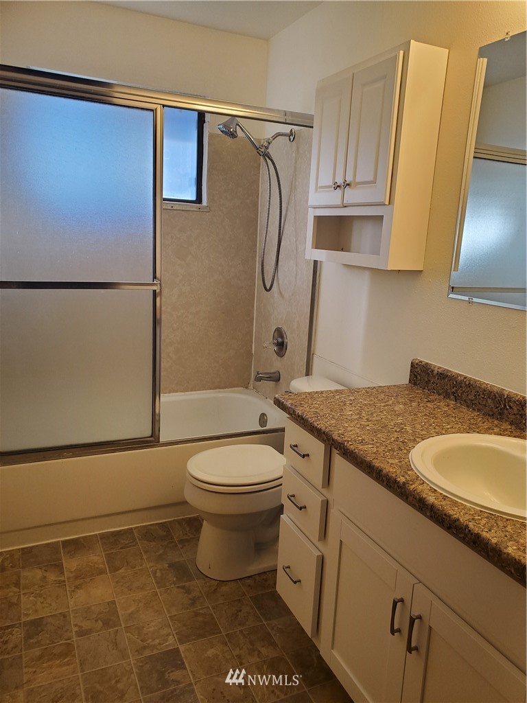 2728 Pine Road Northeast Bremerton, WA 98310 - Photo 14 of 21 a bathroom with a granite countertop sink toilet and shower