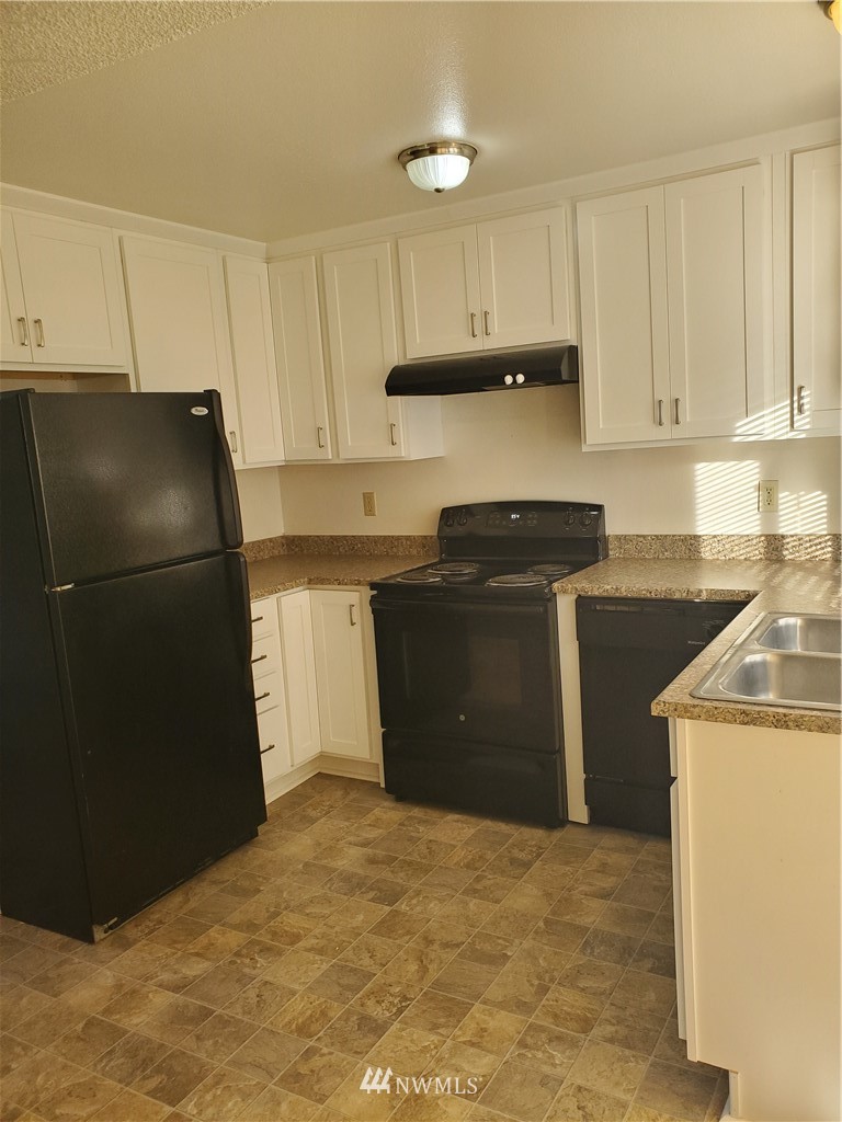 2728 Pine Road Northeast Bremerton, WA 98310 - Photo 15 of 21 a kitchen with a refrigerator and a stove