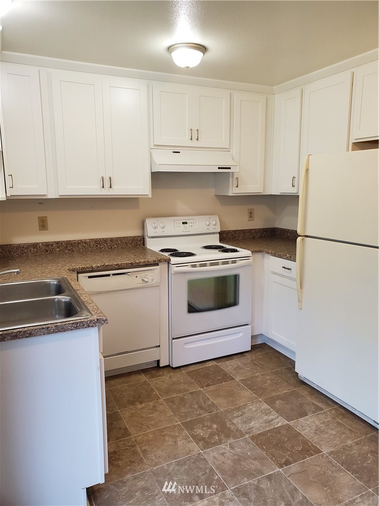 2728 Pine Road Northeast Bremerton, WA 98310 - Photo 9 of 21 a kitchen with white cabinets and white appliances