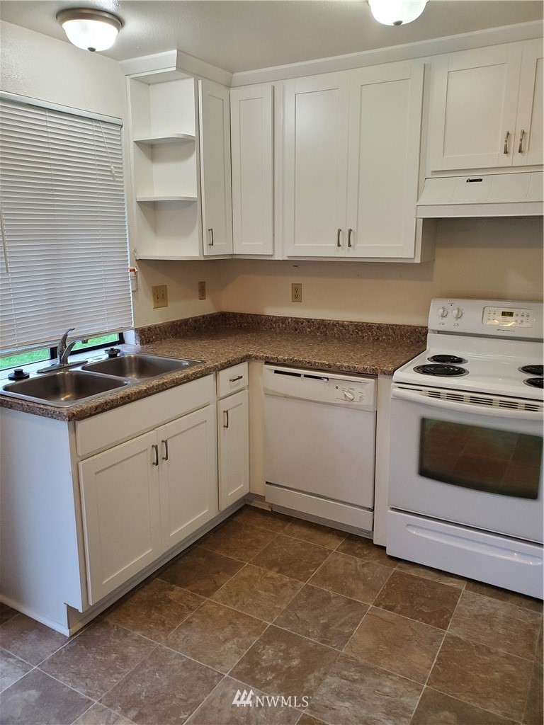 2728 Pine Road Northeast Bremerton, WA 98310 - Photo 10 of 21 a white kitchen with granite countertop stainless steel appliances