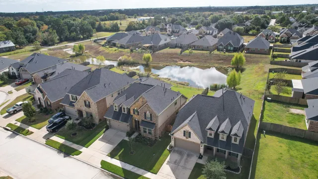 an aerial view of a house with a swimming pool