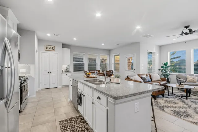 a kitchen with stainless steel appliances a stove sink microwave and cabinets