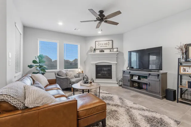 a living room with furniture and a kitchen area