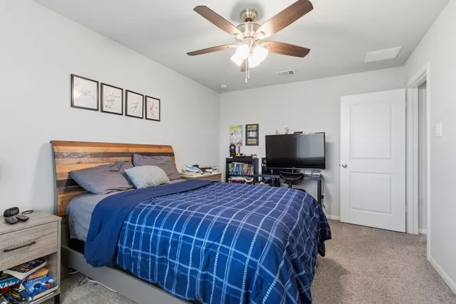 a bedroom with a bed and a chandelier