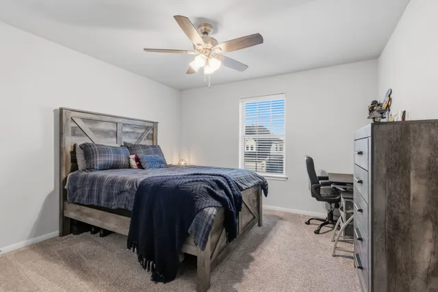 a bedroom with a bed and a desk