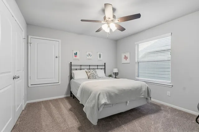 a view of a backyard with table and chairs under an umbrella