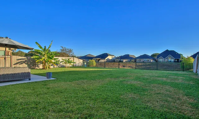an aerial view of residential houses with outdoor space and city view